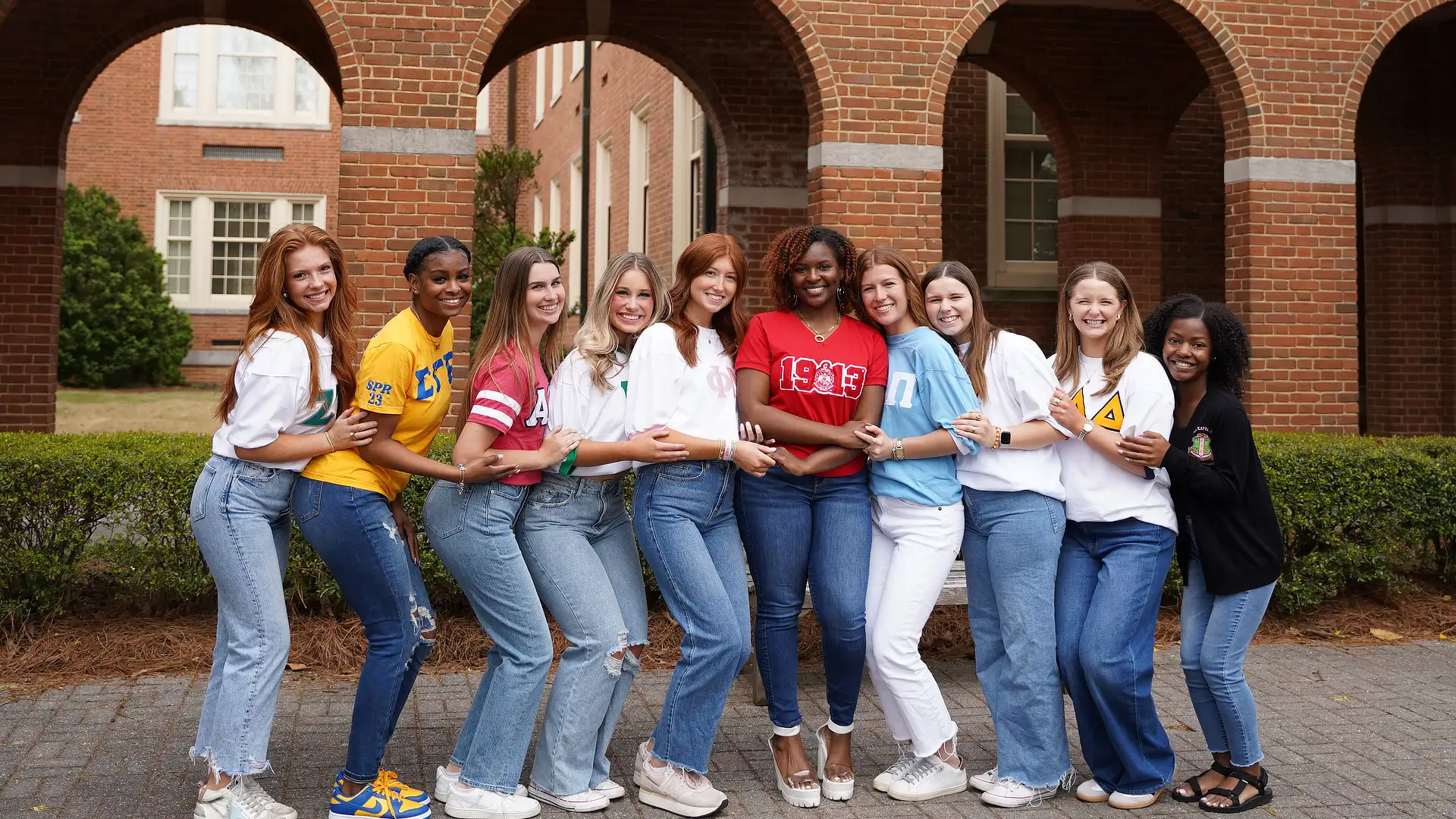 female greeklife students standing in a courtyard